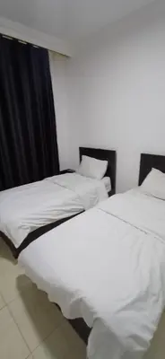 two beds sitting next to each other in a room at شقق الجبيهة العائلية in Amman