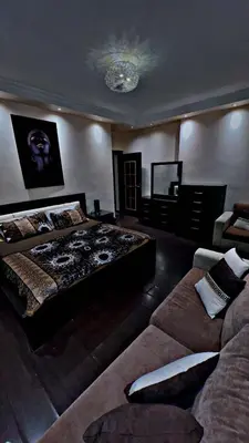 a large bedroom with a bed and a couch at شقه مفروشه in Jurf ad Darāwīsh