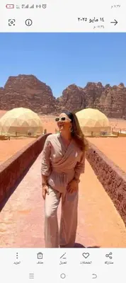 a woman standing on a path in the desert at wadi Rum in Jurf ad Darāwīsh