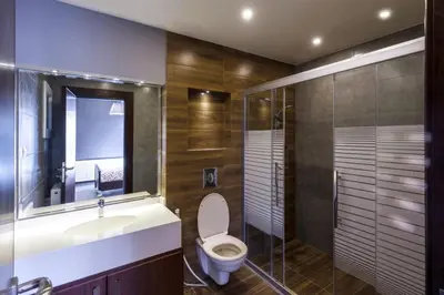 a bathroom with a toilet and a sink and a shower at Der Ghbar Luxe in Amman