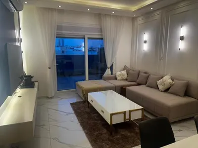 a living room with a couch and a coffee table at Der Ghbar Luxe in Amman