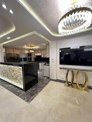 a large kitchen with a chandelier and a counter with two rings on it at الازرق فارم in Al Azraq ash Shamālī