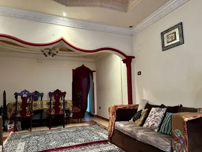 a living room with a couch and a table and chairs at الصدقه ان in Aş Şadaqah