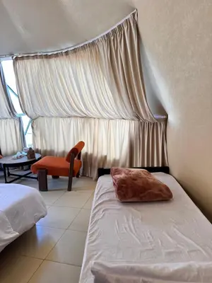 a bedroom with a bed with a pillow on it at Wadi Rum Sha ar Nights in Wadi Rum