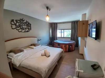a bedroom with a bed with two pillows on it at Layaali Amman Hotel Airport Pickup in Amman