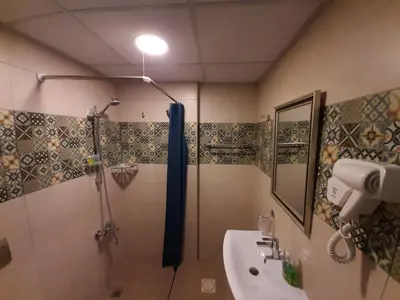 a bathroom with a shower and a sink at Layaali Amman Hotel Airport Pickup in Amman