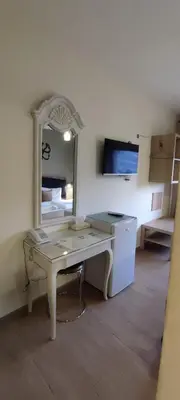 a desk with a mirror in a room at Layaali Amman Hotel Airport Pickup in Amman