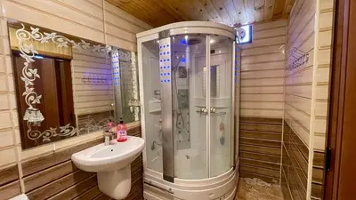 a bathroom with a shower and a sink at كوخ واستراحة شيخ الجبل in Ajloun