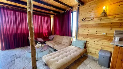 a living room with a couch and a table at كوخ واستراحة شيخ الجبل in Ajloun