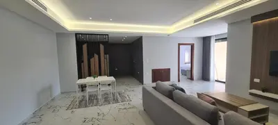 a living room with a couch and a table at فورتاليزا للإسكان in Jurf ad Darāwīsh