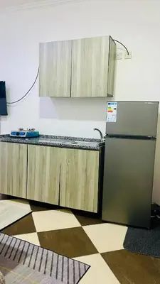a kitchen with a counter and a refrigerator at Al safa in Amman