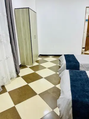 a room with a bed and a checkerboard floor at Al safa in Amman