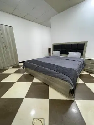 a bedroom with a large bed on a checkered floor at Al safa in Amman