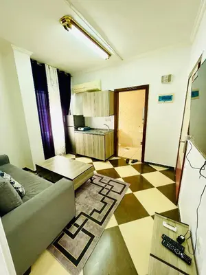 a living room with a couch and a checkered floor at Al safa in Amman