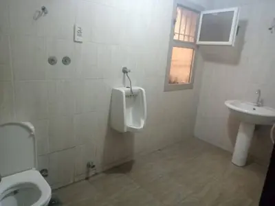 a bathroom with a urinal and a toilet and a sink at صبحه هاوس in Şabḩā