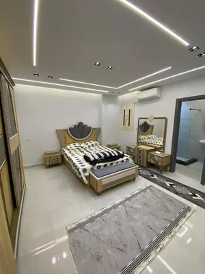 a large bedroom with two beds and a rug at شلنر موتل in Khirbat ar Ruşayfah