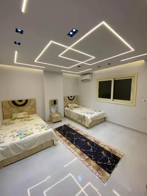 two beds in a room with two windows at شلنر موتل in Khirbat ar Ruşayfah