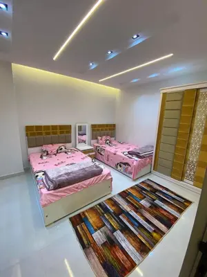 a room with three beds and a rug at شلنر موتل in Khirbat ar Ruşayfah