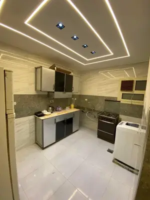 a large kitchen with white tile flooring and a ceiling at شلنر موتل in Khirbat ar Ruşayfah