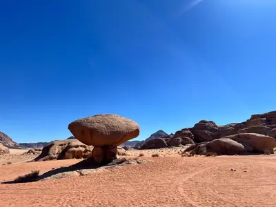 a large rock in the middle of the desert at Wadi Rum Desert Experience in Wadi Rum