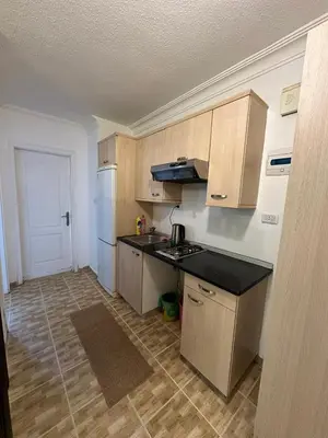 a kitchen with a counter top and a refrigerator at MK4 - One Bedroom Apartment in Amman