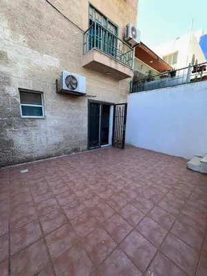 an empty patio in front of a building with a balcony at MK4 - One Bedroom Apartment in Amman