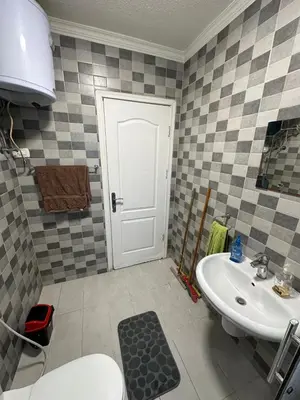 a bathroom with a toilet and a sink at MK4 - One Bedroom Apartment in Amman