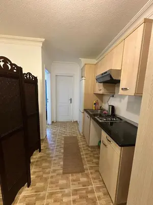 a kitchen with a stove and a counter top at MK4 - One Bedroom Apartment in Amman