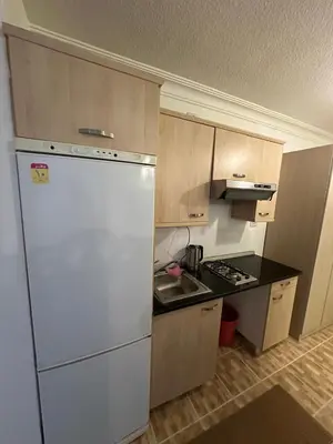 a kitchen with a white refrigerator and a sink at MK4 - One Bedroom Apartment in Amman