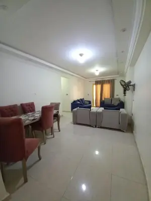 a living room with couches and a table and chairs at المزار لوج in Al Mazār
