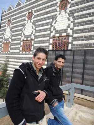 two men are standing in front of a building at man -soor in Amman