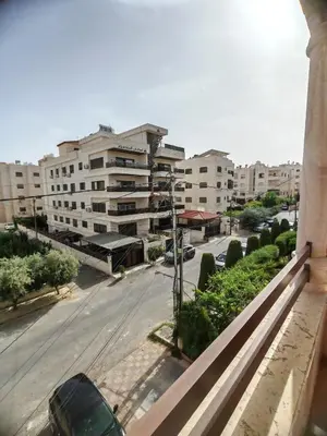 a view of a city street with buildings at Khalda One Bedroom Apt in Amman