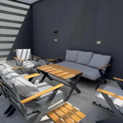 a living room with a couch and a table and chairs at Bow Villa in Sowayma