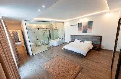 a bedroom with a bed and a tub and a shower at Bow Villa in Sowayma