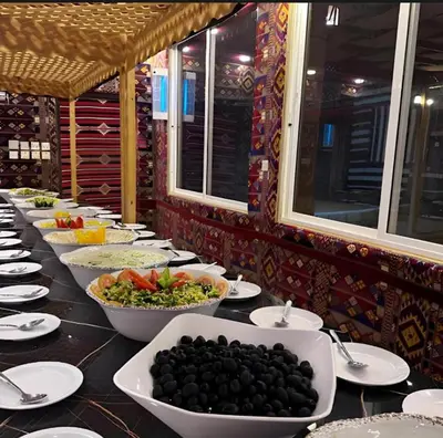 a buffet line with bowls of food on a table at Wadi rum camp hamod in Wadi Rum