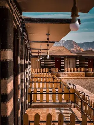 a view of a church with benches and mountains at Wadi rum camp hamod in Wadi Rum