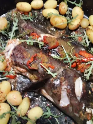 a close up of a grill with meat and vegetables at هيوم شليت in Um Qeis