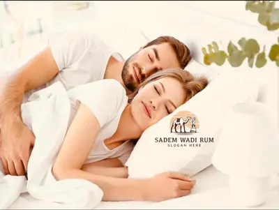 a man and a woman laying in bed at SADEM WADl RUM in Wadi Rum