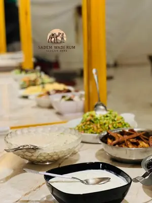 a row of bowls of food on a table at SADEM WADl RUM in Wadi Rum