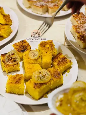 a plate of food on a table with plates of food at SADEM WADl RUM in Wadi Rum