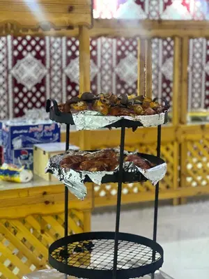a three tiered stand with three tiers of pastries at SADEM WADl RUM in Wadi Rum