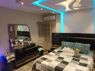 a bedroom with a bed and a large mirror at بليله هاوس in Balīlā