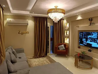 a living room with a couch and a television at بليله هاوس in Balīlā