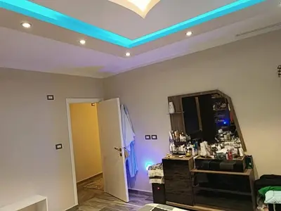 a room with a mirror and a blue light on the ceiling at بليله هاوس in Balīlā