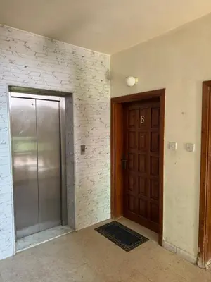 an empty room with a door and a walk in shower at Al-Amer شقق الخامسه الراقيه in Aqaba
