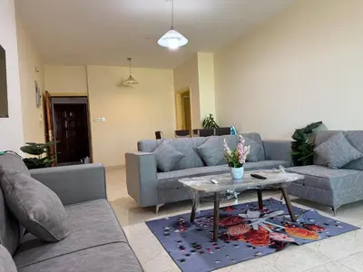 a living room with a couch and a table at Al-Amer شقق الخامسه الراقيه in Aqaba
