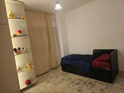 a small bedroom with a bed with a blue blanket at شقة 3غرف نوم في ضاحية الرشيد in Amman
