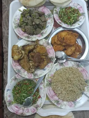 a tray of different types of food on a table at شقه الحنان in Dayr as Si‘nah