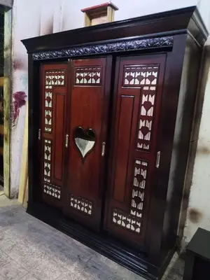 a wooden door with a heart carved into it at شقه الحنان in Dayr as Si‘nah