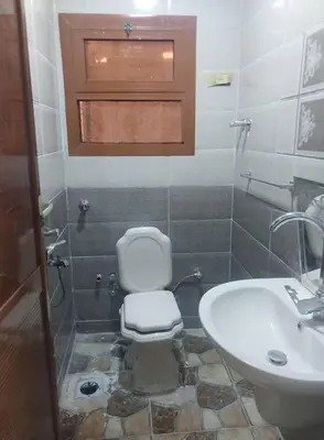 a bathroom with a toilet and a sink at شقه الحنان in Dayr as Si‘nah